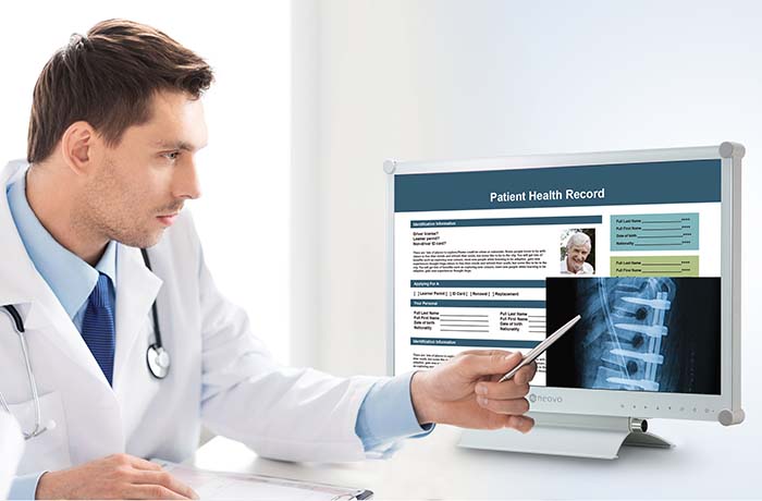 A male doctor is watching X-ray image on AG Neovo MX series DICOM monitor