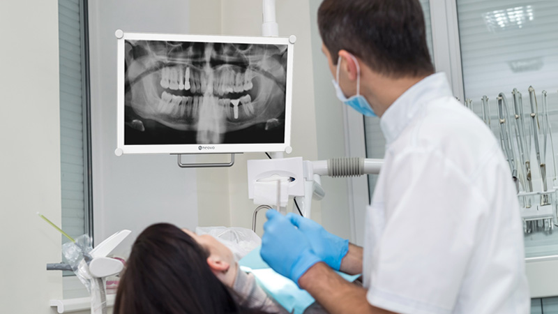 a dentist looking at a Dental Monitors